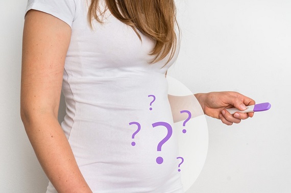Femeie care tine in mana un test de sarcina si spera sa fie insarcinata