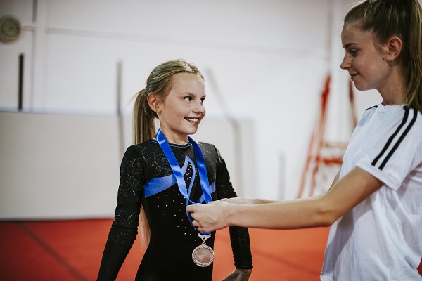 gimnasta adolescenta fericita pentru ca a castigat medalia de aur