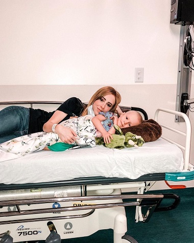 mama stand alaturi de fetita ei cu cancer pe un pat de spital