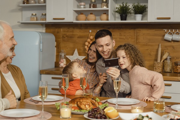 masa in familie, bunici veseli si parinti fericiti alaturi de cei doi copii ai lor