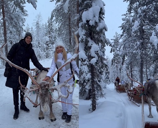 Andreea Balan alaturi de partenerul ei, Victor Cornea, mangaind un ren si impreuna intr-o sanie trasa de reni