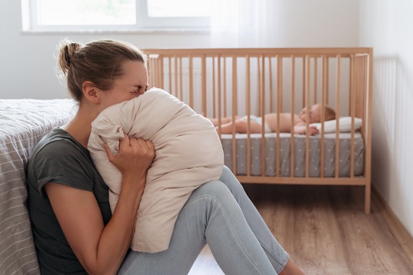 mama care sta pe jos in camera bebelusului ei inabusindu-si fata in perna ca sa nu rabufneasca