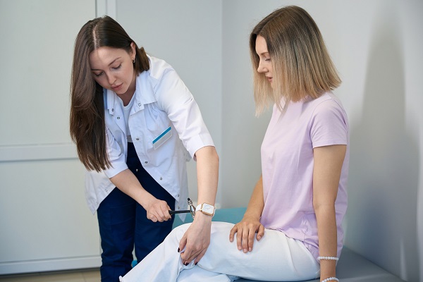 medic neurolog care controleaza reflexele pacientei sale