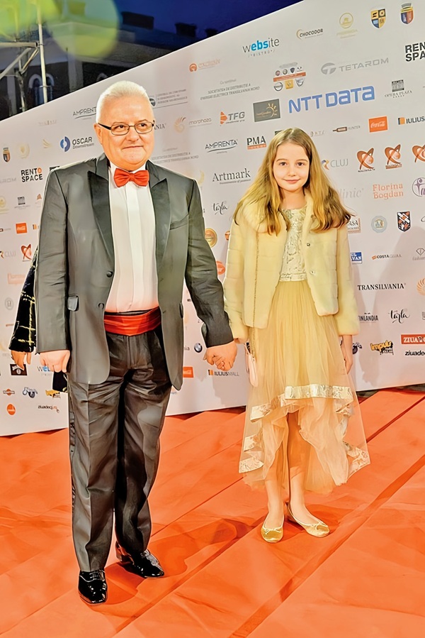 irinel columbeanu in costum gri si camasa alba de mana cu irina columbeanu in rochie lunga galbena