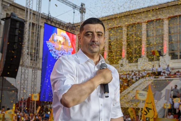 george simion in camasa alba cu mana la piept in spate tricolorul