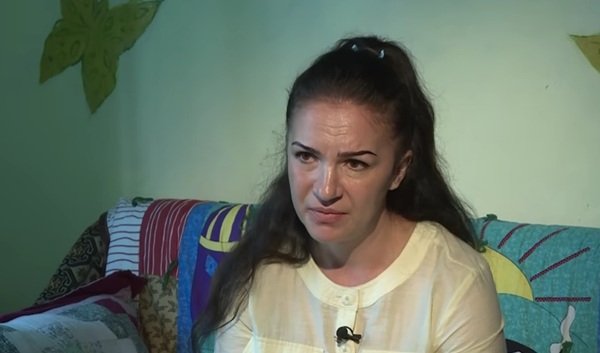 femeie in bluza galbena cu parul prins da un interviu