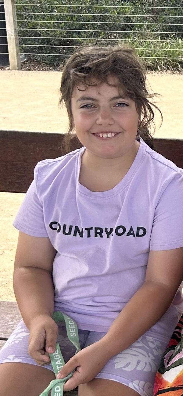 fetita imbracata in mov cu parul prins in coada