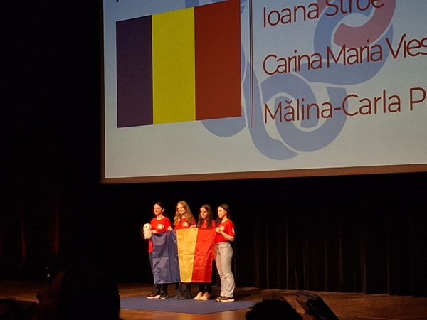 4 eleve romance pe un podium cu steagul romaniei in spate