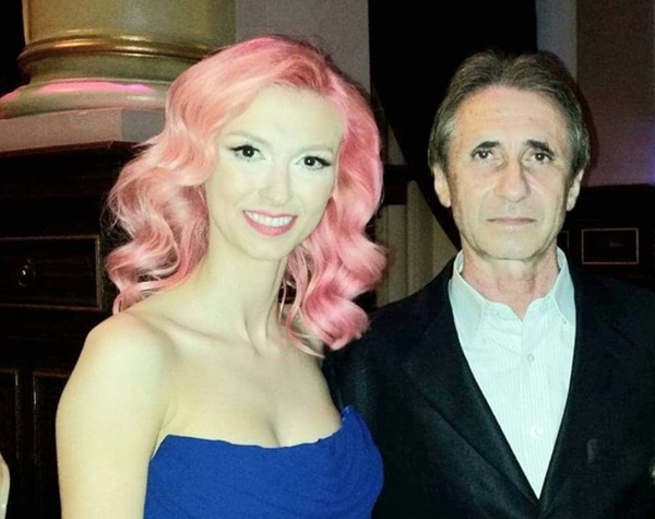 andreea balan cu parul roz si rochie albastra alaturi de tatal ei in costum negru