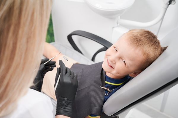 baiat blond zambeste pe scaunul dentistului