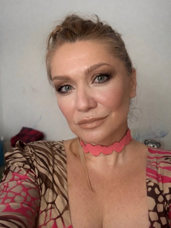 cristina cioran machiata cu parul prins imbracata in rochie inflorata