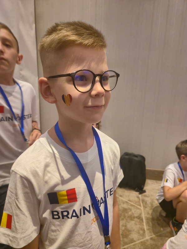 baiat blond cu ochelari de vedere imbracat in tricou alb cu tricolorul pictat pe obraz