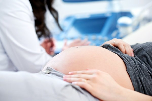 doctorita face ecografie unei femei insarcinate la o clinica