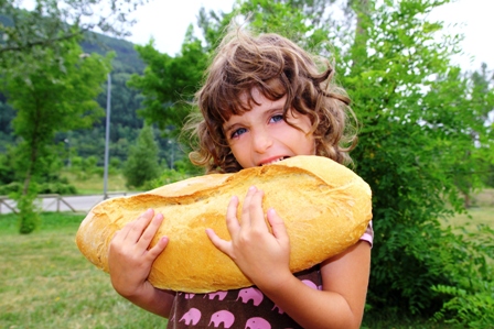 poza fetita flamanda care mananca o paine